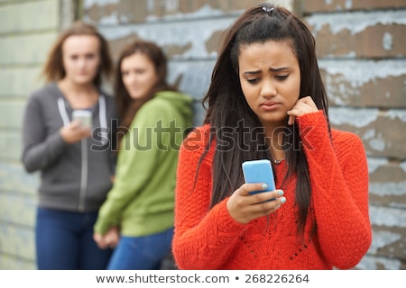 Stockfoto: Teenage Girl Being Bullied By Text Message On Mobile Phone