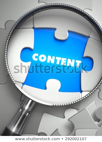 Foto stock: Content - Puzzle With Missing Piece Through Loupe