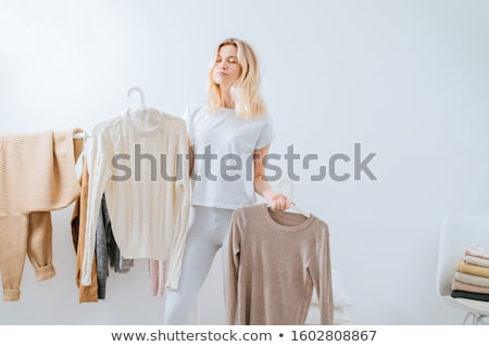 Foto stock: Woman In Dress Standing Near A House Wall