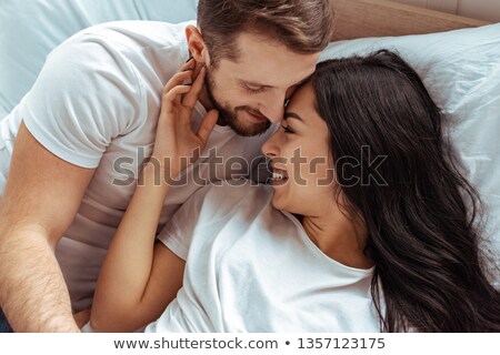 [[stock_photo]]: Tender Attractive Young Woman Lying On Bed