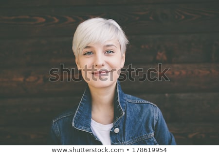 Zdjęcia stock: Smiling Young Woman In Jeans Posing On White