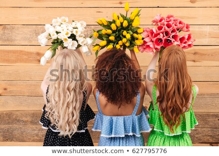 Foto stock: Back View Of Cute African Woman Holding Bouquet Flowers