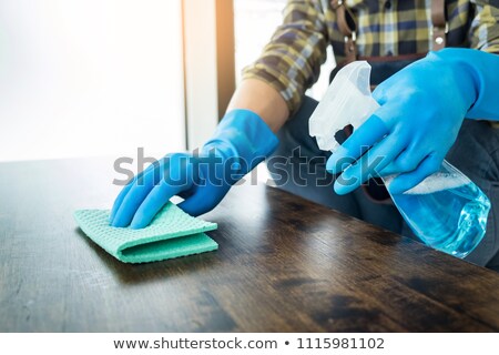 Zdjęcia stock: Man With Cloth Cleaning Wooden Table In Home Uses Rag And Fluid