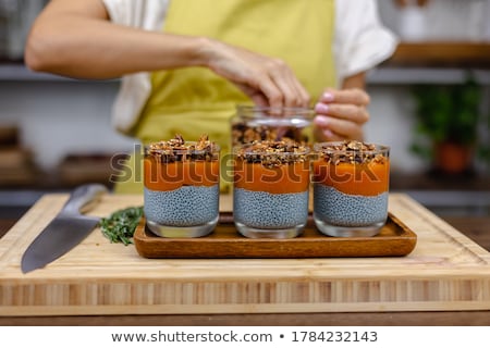 ストックフォト: Chia Seed Pudding With Almond Milk And Fresh Mango Topping On A Wooden Table