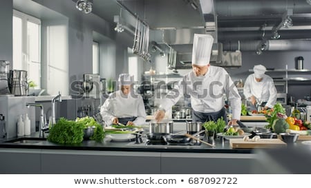 Zdjęcia stock: Chef And Cook Cooking Food At Restaurant Kitchen