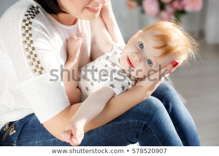 Stok fotoğraf: Portrait Of A Beautiful Mother With Her 2 Month Old Baby In The Bedroom