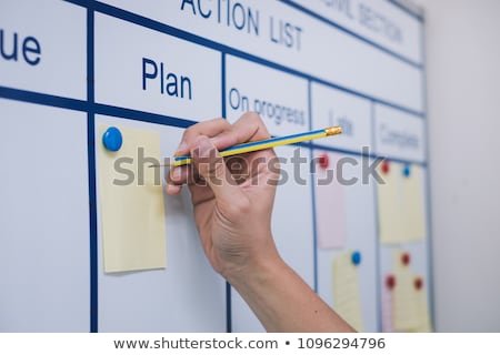 Stock fotó: Person Pointing Writing Goals On A Paperwriting Business Plan A