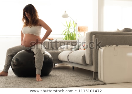 Foto d'archivio: Pregnant Women Sitting On Exercise Balls In Gym
