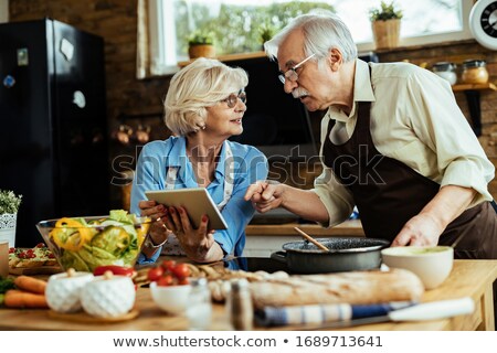 Stockfoto: Senior Man Following Recipe On Digital Tablet