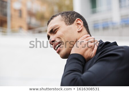 Stock foto: Photo Of Unhappy Strong Sportsman Touching His Neck While Working Out