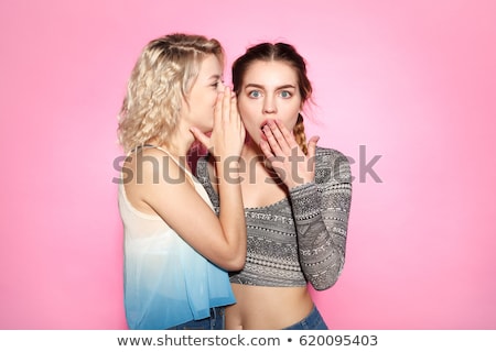 Foto stock: Two Women Whispering And Smiling