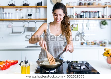 Foto stock: Young Woman Cooking Vegetarian Food