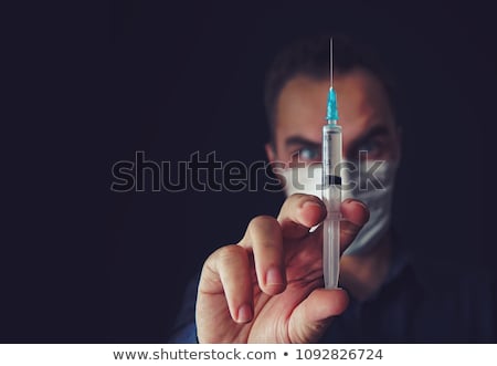 Foto d'archivio: Sinister Doctor With A Syringe