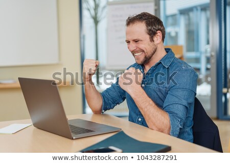 Stock photo: Businessman Raising His Clenched Fists In Front Of Him