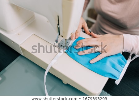 Stockfoto: Woman Using A Sewing Machine