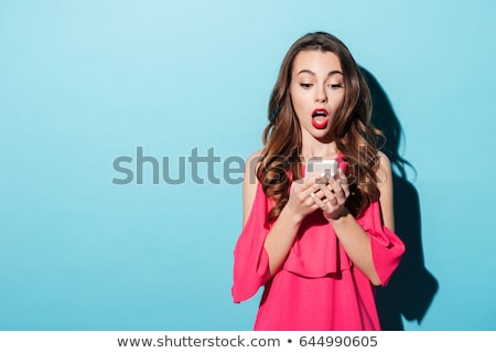 Сток-фото: Surprised Woman With Phone Isolated Background
