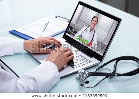 Сток-фото: Doctor Video Conferencing With Female Colleague On Laptop