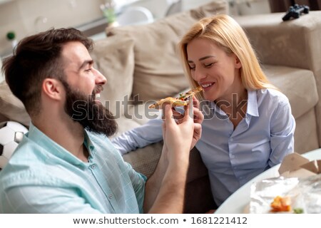 Stock fotó: Couple Relaxing At Home And Eating Tasteful Pizza