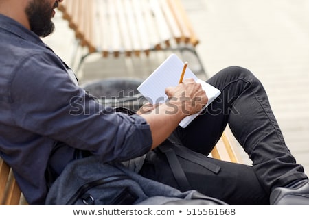 Stock photo: Close Up Of Man Writing To Notebook On City Street