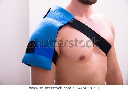 Stock foto: Man With A Ice Pack On His Shoulder