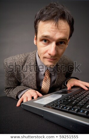 Amusing Portrait Of Man On Workplace At Dark Office Stockfoto © pzAxe