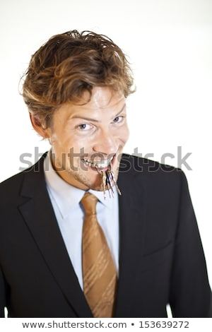 Smiling Businessman Holding Keys Between His Teeth Stock fotó © Rugdal