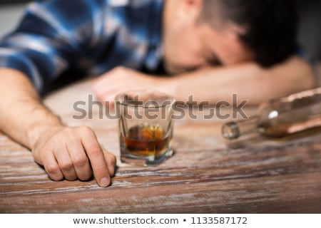 Zdjęcia stock: Man Drinks Alcohol Out Of A Bottle