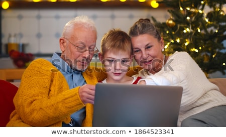 Stock foto: Senior Couple With Grandchildren At Christmas