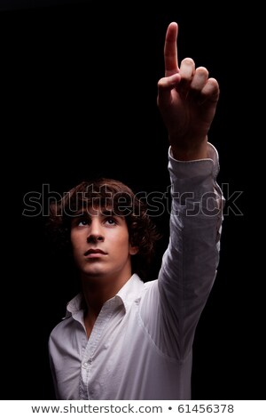 Young Man Looking Up To The Light And Pointing - Sign Of Faith Isolated On Black Studio Shot Stockfoto © AlexandreNunes