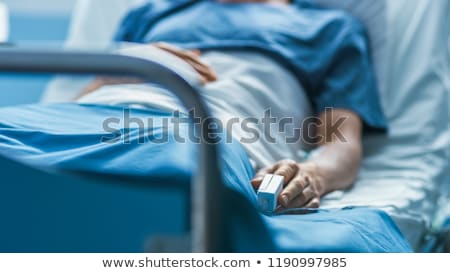 Stockfoto: Patient Lying In Hospital Bed With Heart Monitor