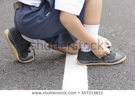 Stock fotó: Child Student Tying Shoes At Roadside