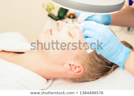 Foto stock: Beautician Makes The Procedure For Cleaning Woman Face