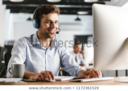 Сток-фото: Photo Of Businesslike Man 20s Wearing Office Clothes And Headset