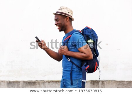 Foto stock: Smiling Young African Man With Backpack Outdoors