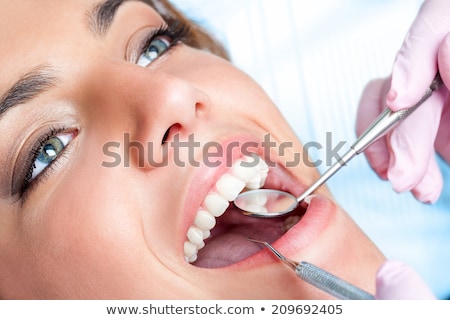 ストックフォト: Womans Smile Healthy White Womans Teeth And A Dentist Mouth Mirror Close Up Dental Hygiene Oral