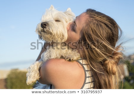[[stock_photo]]: Portrait Of Beautiful Girl Keeping Pretty White West Highland Dog Outdoor