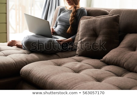 Foto stock: Young Blonde Woman On Couch With Notebook