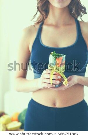 Stock photo: Woman Holding Glass Of Fruits Salad