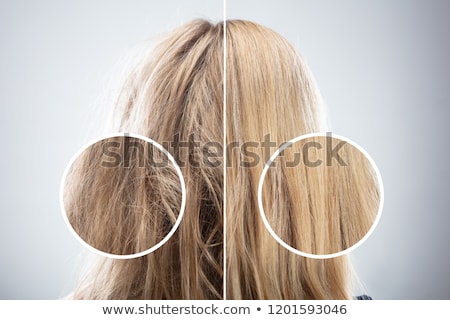 ストックフォト: Curly Haired Blonde Woman In Studio Grey Background