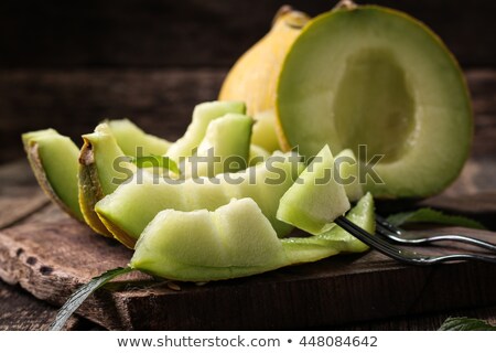 Сток-фото: Slices Of Cantaloupe Melon On Rustic Table