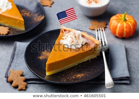 Stok fotoğraf: Pumpkin Pie Tart Made For Thanksgiving Day With Whipped Cream With American Flag On Top