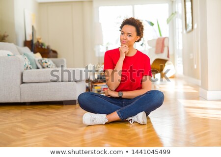 Foto d'archivio: Confident Casual Woman Sitting With Hands Crossed And Smiles