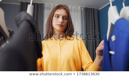 ストックフォト: Woman In A Wardrobe Chooses What To Wear View From Behind