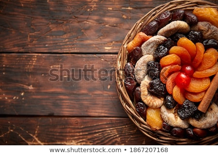 Stock photo: Mix Of Dried Fruits In A Small Wicker Basket On Wooden Table