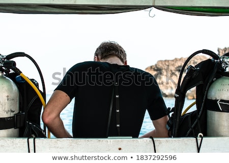 Stock fotó: Diver Prepares His Equipment For Diving In The Sea