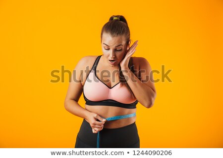 Stockfoto: Portrait Of Caucasian Chubby Woman In Sportive Bra Measuring Her