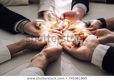 [[stock_photo]]: Teamwork And Brainstorming Concept With Businessmen That Share An Idea With A Lamp Concept Of Start