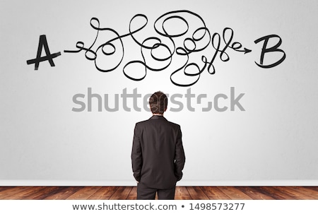 Stockfoto: Businessman Looking For Solution While Standing In Front Of A Wall