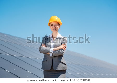 Foto d'archivio: Woman Investor In Clean Energy Standing In Front Of Solar Panels