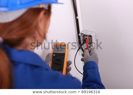 Foto stock: Craftswoman Installing Electricity